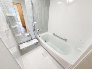 a white bathroom with a tub and a shower at Akatsuki Villa 暁 in Asahikawa