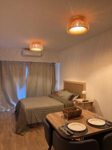 a bedroom with a bed and a table with plates on it at Hermoso departamento Saavedra 4741 in Buenos Aires