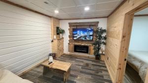 a room with a fireplace and a tv on a wall at cozy corner in Dalton