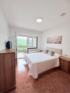 a bedroom with a large bed and a balcony at Casa Romai Portas in Romay +46 photos