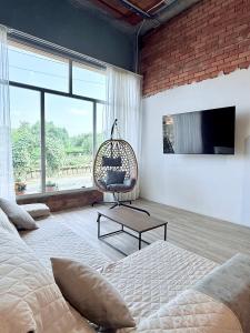 a bedroom with a bed and a hanging chair at Casa Romai Portas in Romay