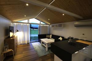 a kitchen and living room with a couch and a table at Häuschen am Traunig in Hermagor