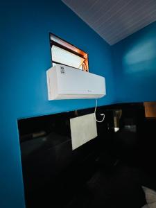 a printer sitting on top of a desk in a blue room at A2 suites Unid Sofia in Jataí