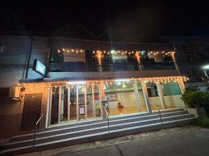 a building with lights on it at night at SOLEIL HAUS - Huahin in Hua Hin