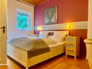 a bedroom with a bed and a window at Zum Burggraf in Neuleiningen +37 photos