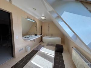 a bathroom with a sink and a bath tub at Jaunkrastmaļi in Kandava +73 photos