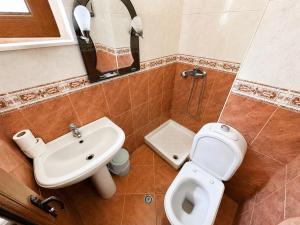 a bathroom with a toilet and a sink at Hotel Mjeshtri in Shëngjin