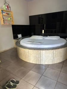 a circular bed in a room with shoes on the floor at A2 suites Unid Sofia in Jataí