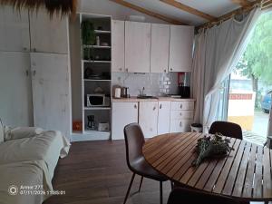 a kitchen with a wooden table and a dining room at Casa do Adro in Corte do Gafo de Cima +6 photos