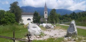 a statue of rocks in front of a church at Villa Alta in Strigno