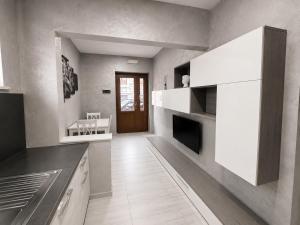 a kitchen with white cabinets and a counter top at Apartment Federico in Melfi