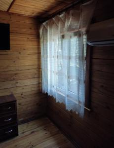 a room with a window in a wooden house at Akacia in Svityazʼ