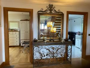 a mirror on a dresser in a living room at Bayview Guest House in Dunkineely