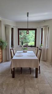 a dining room with a white table and chairs at sPokój na Marsa in Straszyn