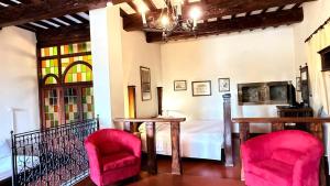 a room with two chairs and a table and a bed at Castello Di Petroia Dimora d'Epoca in Gubbio