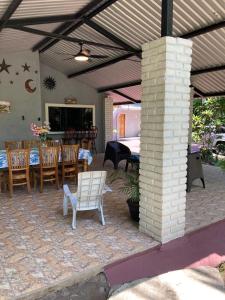 a patio with a table and chairs and a table and chairs at Beach House EL Cocalito in La Libertad