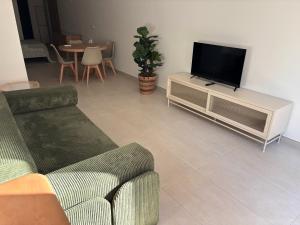 a living room with a couch and a flat screen tv at APARTAMENTO LEPANTO in Almazora