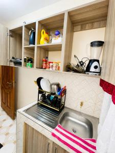 a kitchen with a sink and a counter top at Nyeri 1 Bedroom BnB in Nyeri