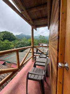 a balcony with benches on top of a house at Greengoat Haven in Santa Marta