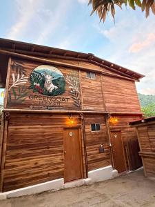 a building with a sign on the side of it at Greengoat Haven in Santa Marta +14 photos