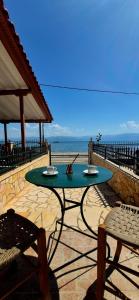 a table and chairs sitting on a patio near the ocean at Petalidi seaside Retreat in Petalidi