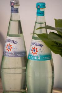 two bottles of water sitting next to each other at Restaurant Hotel Friesdorfer Hof in Bonn