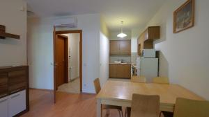 a kitchen and dining room with a table and chairs at Villa Palazzo Apartments in Siófok +17 photos