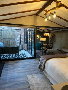 a bedroom with a bed and a living room at Nest-Dove's Nest in Howick