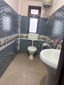 a bathroom with a toilet and a sink at The Mirik Address in Mirik