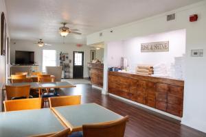a restaurant with tables and chairs and a counter at Hatteras Island Inn in Buxton