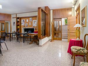 a living room with tables and chairs and a dining room at Villa Francesca Luxury Rooms in San Demetrio Corone