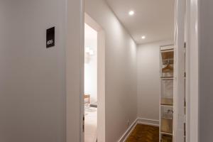 a hallway with a door leading into a room at Home Out Rooms & Apartments in Lisbon