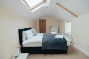 a bedroom with a large bed in a attic at The Welsh Welcome in Pen-y-groes