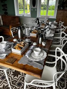 a long wooden table with plates of food on it at La Haute Muraille in Saint-Folquin