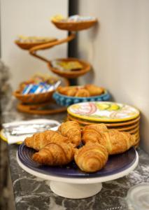 a plate of croissants and other pastries on a table at Tao chambre in Taormina +36 photos