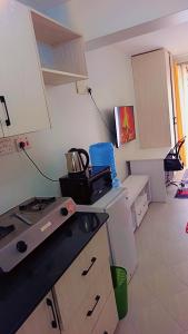 a kitchen with a stove and a counter top at Amaziah apartment Mimyhomes in Nairobi