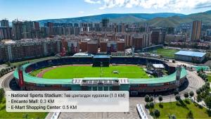 an aerial view of a soccer stadium with a city at Newly Renovated Japandi 1BR Near Shangri-La in Ulaanbaatar