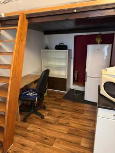 an office with a desk and a chair in a room at Cozy studio near the Hot Spring in Karlovy Vary +3 photos