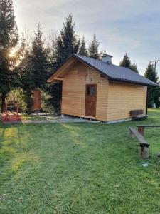 a small wooden cabin in the middle of a field at Domek u Ani 4 in Orelec