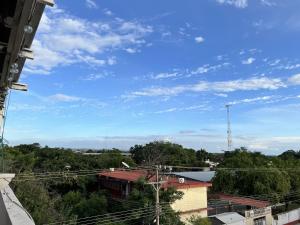 a view of a blue sky with trees and buildings at Hotel Cielo Huasteco in Ciudad Valles