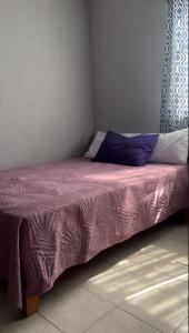a bed in a room with purple sheets and pillows at Hotel Cielo Huasteco in Ciudad Valles +2 photos