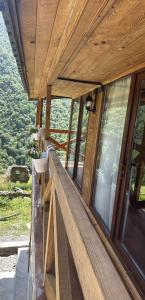 a house with a balcony with a view of the mountains at Guesthouse Mountain House in Khalde