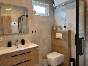 a bathroom with a toilet and a sink at Apartman Bor in Kiseljak