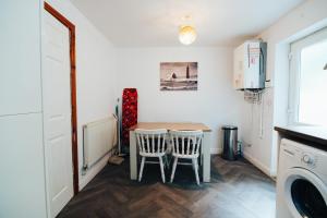 a small kitchen with a table and two chairs at The Coastal Breeze in Porthmadog