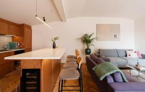 a kitchen and living room with a couch and a table at Jannseni Premium Penthouse I Sauna I Free Parking in Pärnu +63 photos