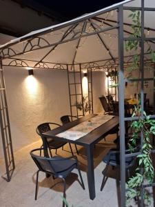 a table and chairs under an umbrella in a room at Blue and white in Pleven
