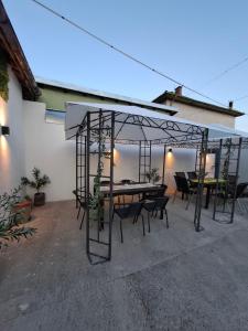 a patio with tables and chairs under a tent at Blue and white in Pleven
