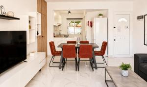 a kitchen and living room with a table and chairs at Nerina Townhouse By Staycom in Paphos