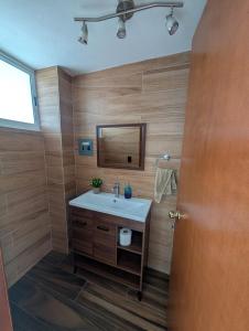 a bathroom with a sink and a mirror at Casa Terraza Zacatlan in Zacatlán +36 photos
