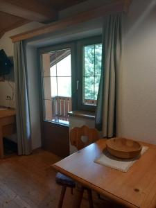 a wooden table with a bowl on top of it at Bad Kalkstein in Innervillgraten +23 photos